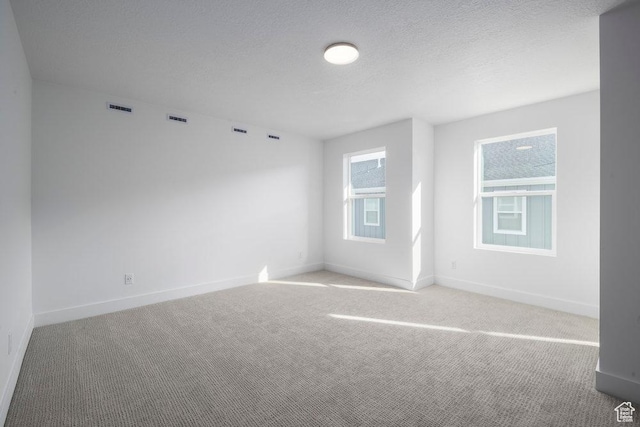 1773 W 160 S Unit 43, Pleasant Grove, UT 84062 - spare room with visible vents, light colored carpet, a textured ceiling, and baseboards