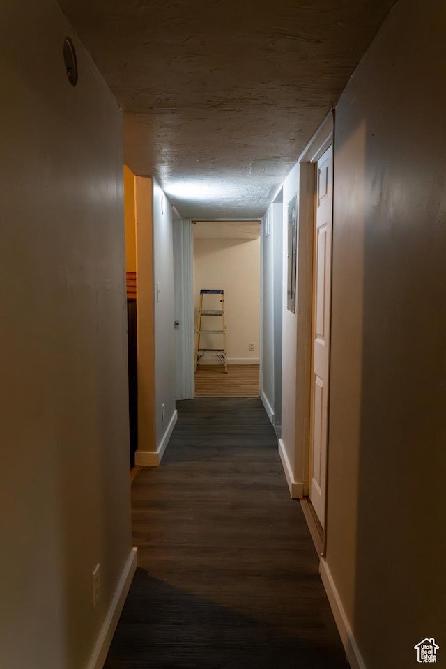 corridor featuring dark wood-type flooring