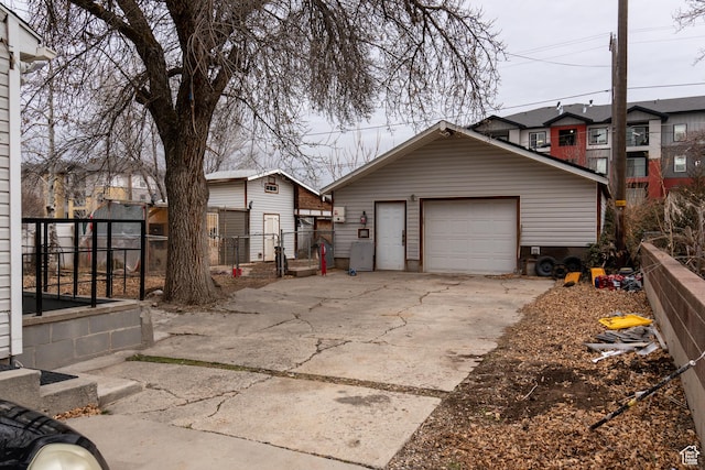 view of front of house featuring a garage and an outbuilding