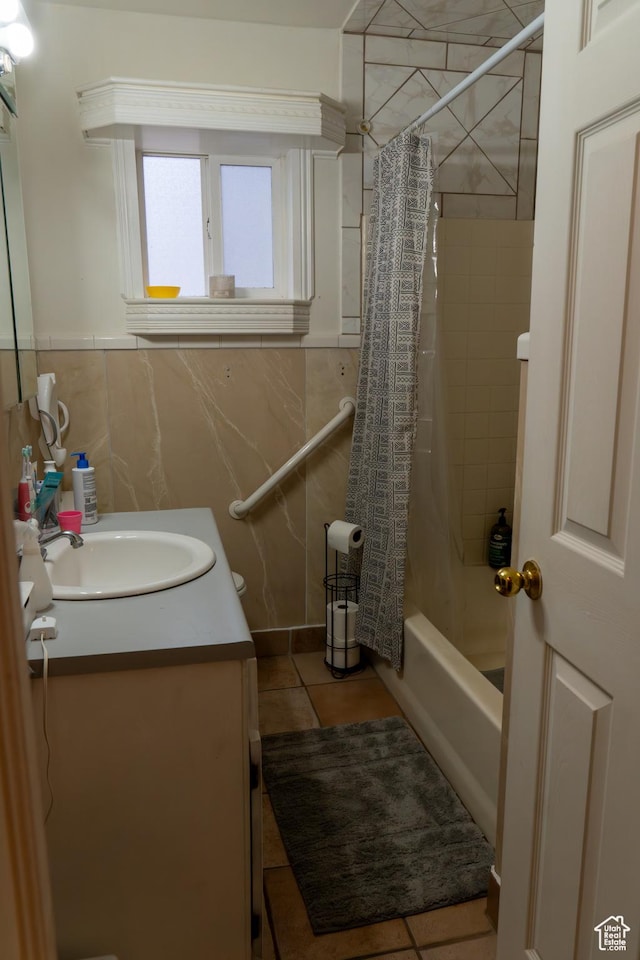 bathroom with tile walls, vanity, tile patterned floors, and shower / bath combo with shower curtain