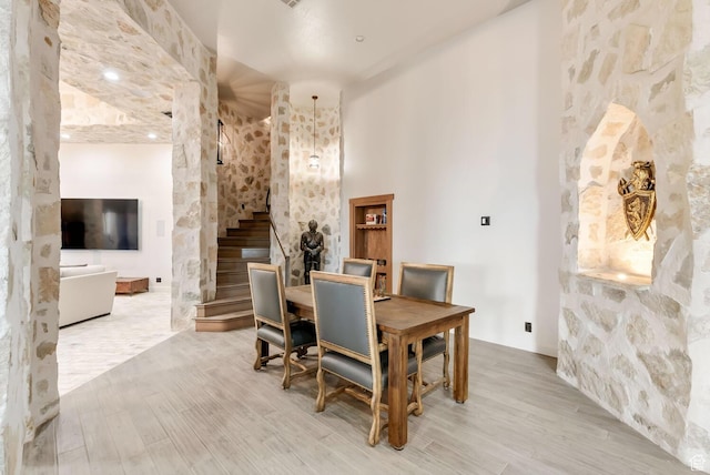 2836 S 2300th Cir E, St George, UT 84790 - dining room featuring a towering ceiling, light wood finished floors, and stairs