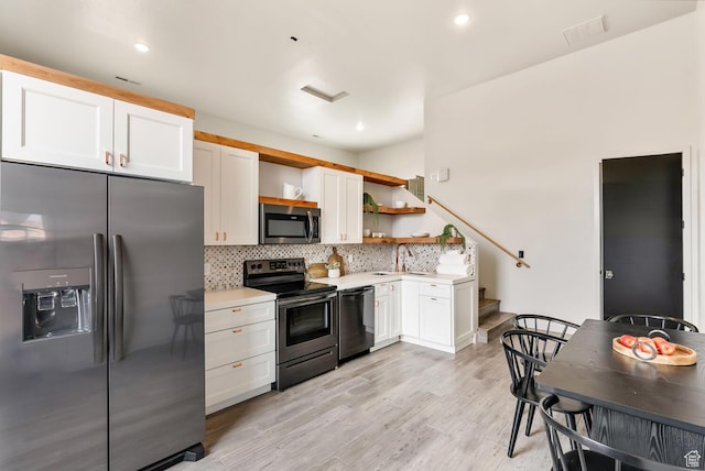 2836 S 2300th Cir E, St George, UT 84790 - kitchen with white cabinets, light countertops, appliances with stainless steel finishes, decorative backsplash, and open shelves