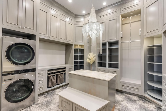 2836 S 2300th Cir E, St George, UT 84790 - clothes washing area with stacked washer / drying machine, cabinet space, recessed lighting, and an inviting chandelier
