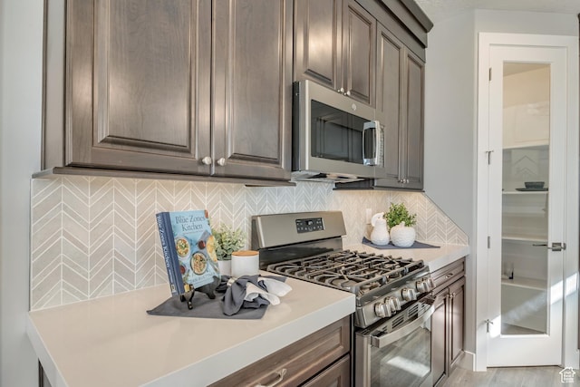 3791 S 3235 W Unit 15, West Haven, UT 84401 - kitchen with appliances with stainless steel finishes, dark brown cabinets, and tasteful backsplash