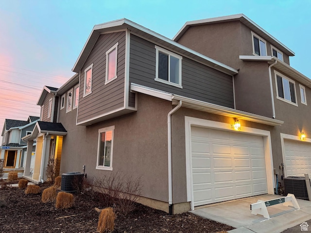 3791 S 3235 W Unit 15, West Haven, UT 84401 - property exterior at dusk with a garage and cooling unit
