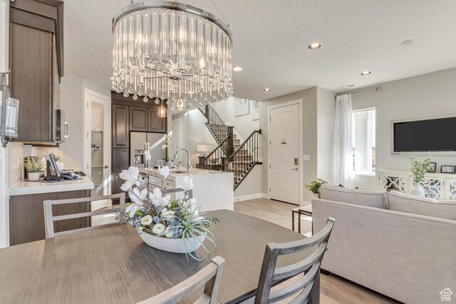 3791 S 3235 W Unit 15, West Haven, UT 84401 - dining area featuring light hardwood / wood-style floors and a chandelier
