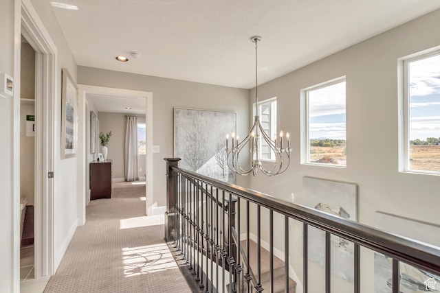 3791 S 3235 W Unit 15, West Haven, UT 84401 - hallway featuring light colored carpet and a notable chandelier