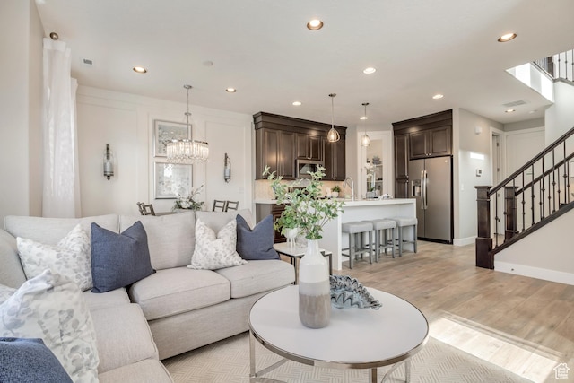 3791 S 3235 W Unit 15, West Haven, UT 84401 - living room featuring sink, a chandelier, and light hardwood / wood-style flooring
