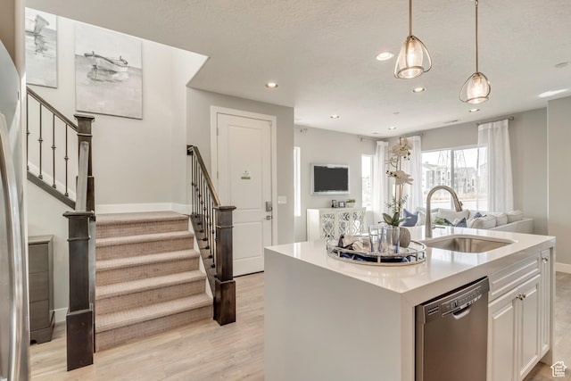 3791 S 3235 W Unit 15, West Haven, UT 84401 - kitchen featuring sink, white cabinetry, stainless steel dishwasher, hanging light fixtures, and a kitchen island with sink