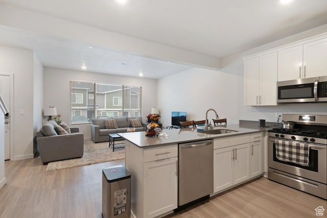 3788 W Soft Whisper Way, Herriman, UT 84096 - kitchen with sink, kitchen peninsula, appliances with stainless steel finishes, and white cabinetry