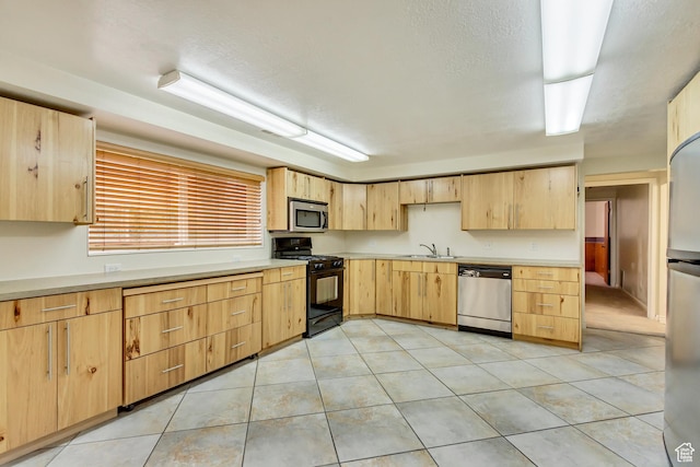 3780 W 5850 S, Roy, UT 84067 - kitchen featuring light tile patterned floors, stainless steel appliances, light brown cabinetry, and sink