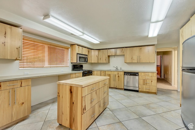 3780 W 5850 S, Roy, UT 84067 - kitchen with appliances with stainless steel finishes, sink, a center island, and light brown cabinets