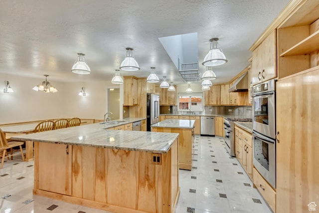 3780 W 5850 S, Roy, UT 84067 - kitchen featuring appliances with stainless steel finishes, light brown cabinetry, a spacious island, and pendant lighting
