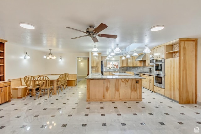 3780 W 5850 S, Roy, UT 84067 - kitchen featuring hanging light fixtures, light brown cabinetry, wall chimney exhaust hood, light stone counters, and stainless steel appliances