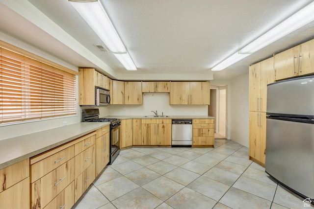 3780 W 5850 S, Roy, UT 84067 - kitchen with light tile patterned flooring, stainless steel appliances, light brown cabinets, and sink
