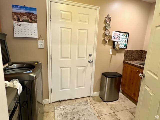 4547 S 1250 W, Riverdale, UT 84405 - washroom with cabinet space, light tile patterned floors, and baseboards