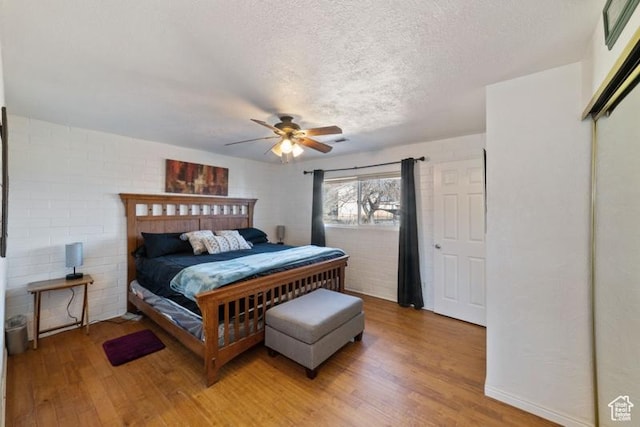 992 N 2050 E, St George, UT 84770 - bedroom with hardwood / wood-style flooring, ceiling fan, a textured ceiling, and a closet