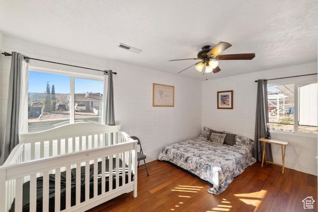 992 N 2050 E, St George, UT 84770 - bedroom featuring multiple windows, a textured ceiling, ceiling fan, and dark hardwood / wood-style floors