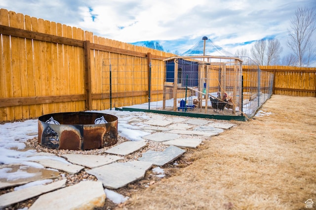 yard covered in snow featuring an outdoor fire pit and a gazebo