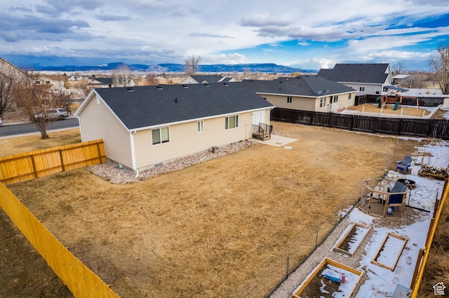 back of house with a mountain view