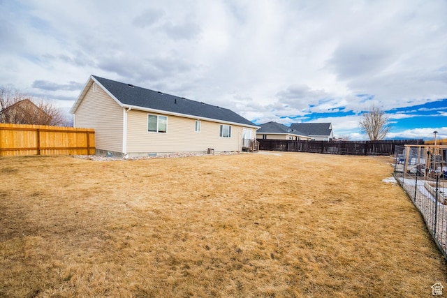 rear view of house featuring a lawn