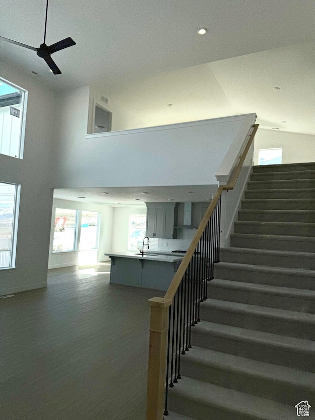 2895 E Liam Ln Unit 106, Eagle Mountain, UT 84005 - stairs with ceiling fan, baseboards, wood finished floors, recessed lighting, and high vaulted ceiling