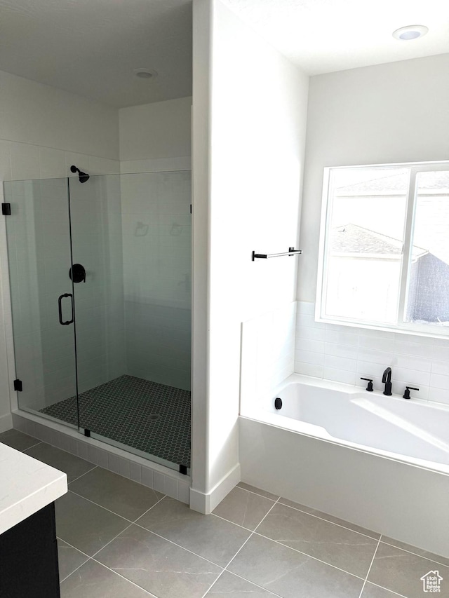 2895 E Liam Ln Unit 106, Eagle Mountain, UT 84005 - full bath featuring tile patterned flooring, vanity, a shower stall, and a garden tub