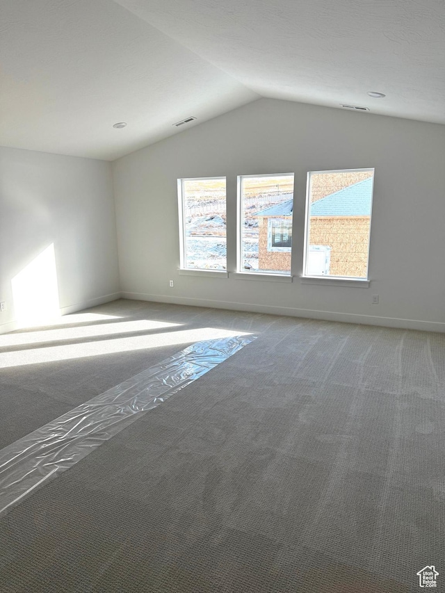 2895 E Liam Ln Unit 106, Eagle Mountain, UT 84005 - carpeted spare room with baseboards, vaulted ceiling, and visible vents