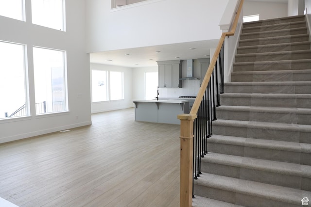 2895 E Liam Ln Unit 106, Eagle Mountain, UT 84005 - stairs with wood finished floors and a towering ceiling