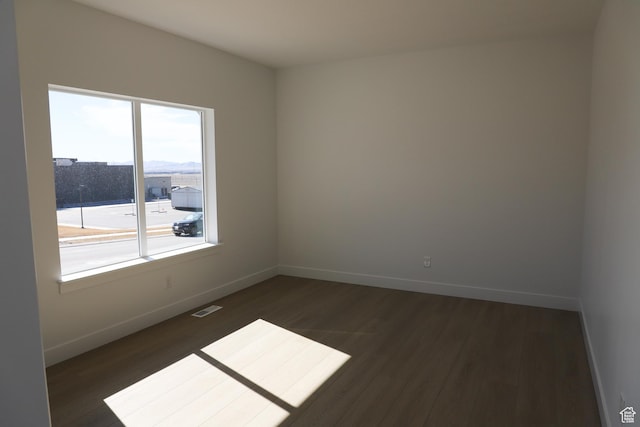 2895 E Liam Ln Unit 106, Eagle Mountain, UT 84005 - unfurnished room featuring dark wood-style floors and baseboards