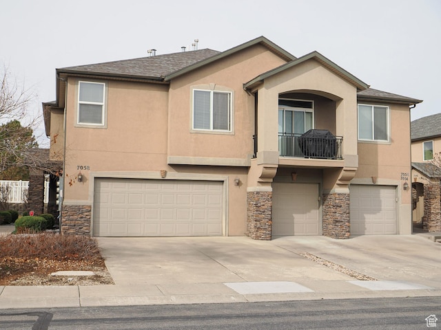 view of front of property with a balcony and a garage