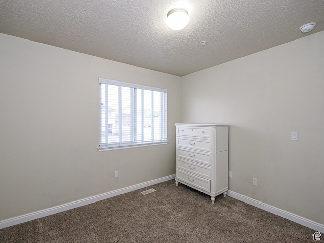 7058 S Greensand Dr, West Jordan, UT 84084 - spare room with dark carpet and a textured ceiling