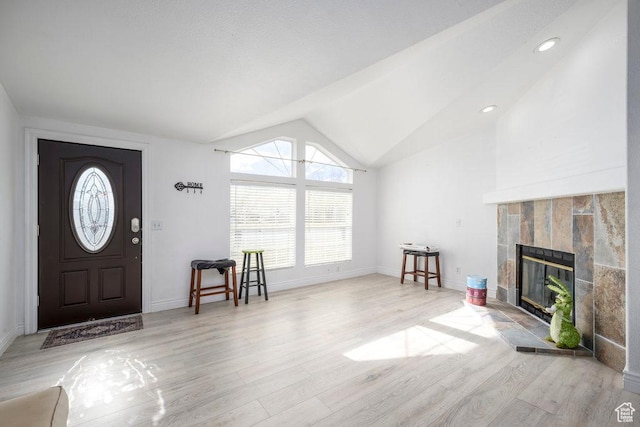 115 E 470 N, Centerfield, UT 84622 - entryway with lofted ceiling, light wood-style flooring, baseboards, and a tile fireplace