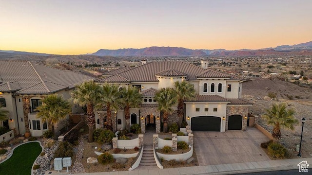 2024 W 450th Cir S, St George, UT 84770 - mediterranean / spanish home with a tile roof, stucco siding, a mountain view, and driveway