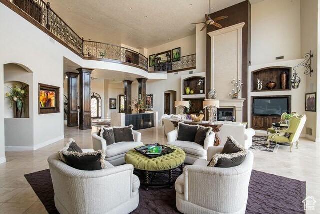 2024 W 450th Cir S, St George, UT 84770 - interior space with decorative columns, baseboards, a high ceiling, arched walkways, and a fireplace