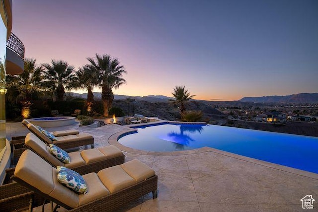 2024 W 450th Cir S, St George, UT 84770 - view of swimming pool with a mountain view, an infinity pool, a patio, and an in ground hot tub