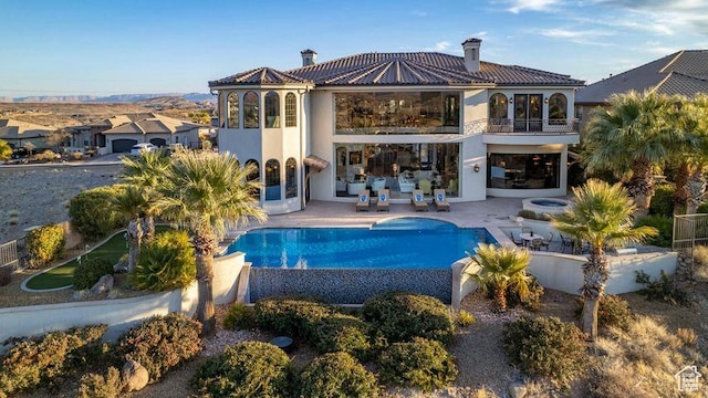 2024 W 450th Cir S, St George, UT 84770 - rear view of house with stucco siding, a patio area, a tiled roof, a balcony, and a fenced in pool