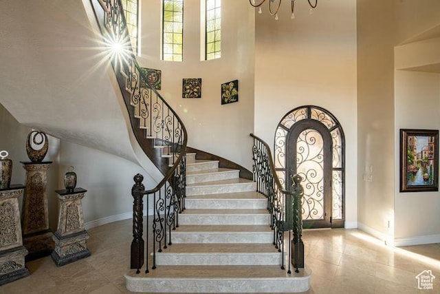 2024 W 450th Cir S, St George, UT 84770 - foyer with baseboards, stairs, a high ceiling, and light tile patterned flooring