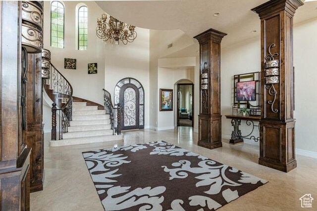 2024 W 450th Cir S, St George, UT 84770 - entrance foyer with baseboards, ornate columns, arched walkways, stairs, and a high ceiling