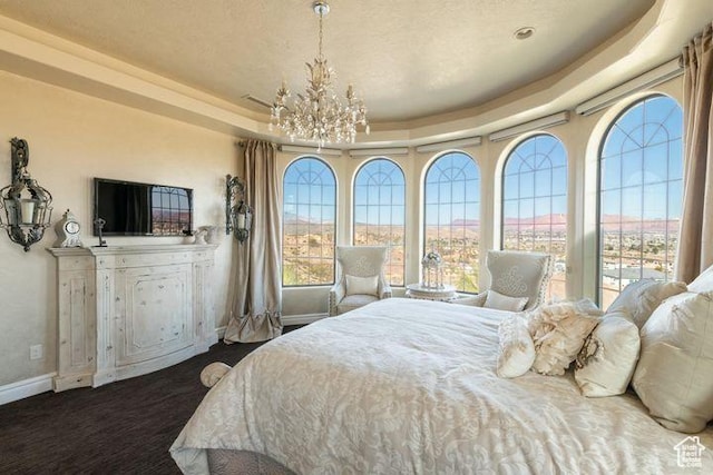 2024 W 450th Cir S, St George, UT 84770 - bedroom with baseboards, a raised ceiling, and a notable chandelier