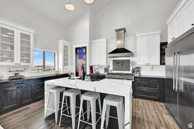 2673 S 4950 W, Taylor, UT 84401 - kitchen featuring wall chimney exhaust hood, high quality fridge, a kitchen island, and glass insert cabinets