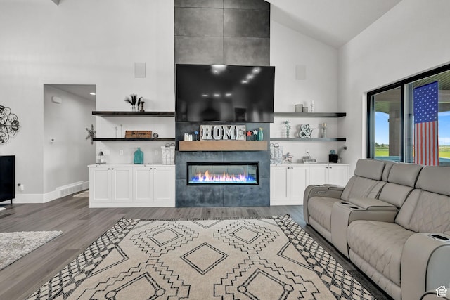 2673 S 4950 W, Taylor, UT 84401 - living area featuring dark wood-style floors, baseboards, high vaulted ceiling, and a tiled fireplace