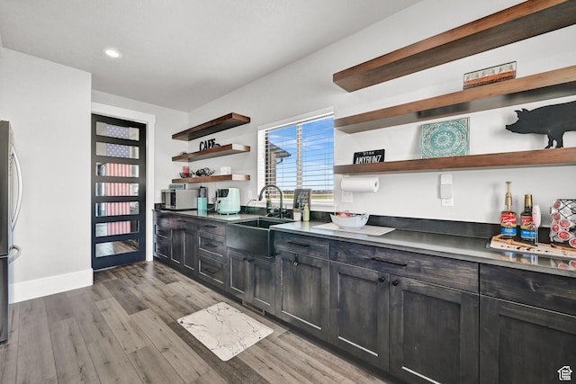 2673 S 4950 W, Taylor, UT 84401 - kitchen featuring light wood-style floors, a sink, baseboards, and open shelves