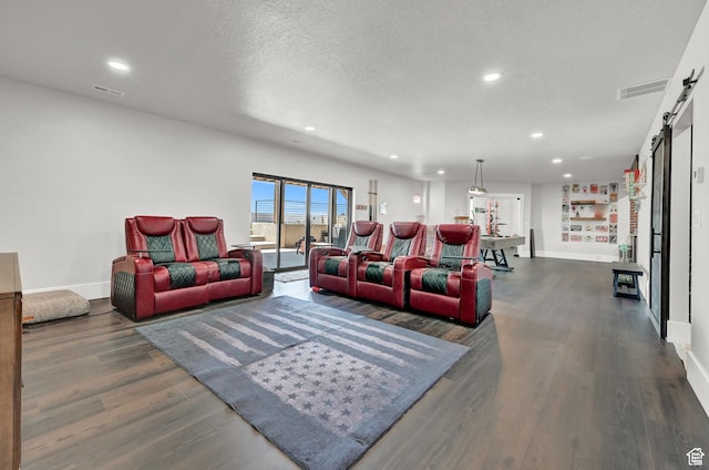 2673 S 4950 W, Taylor, UT 84401 - living area with dark wood-type flooring, visible vents, a textured ceiling, and a barn door