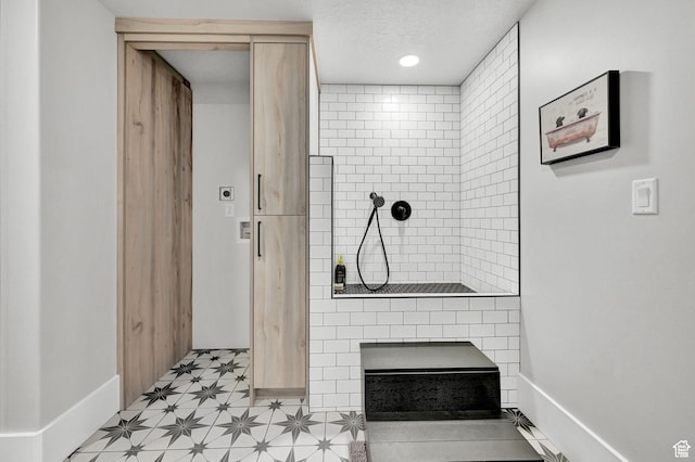 2673 S 4950 W, Taylor, UT 84401 - bathroom with baseboards, a tile shower, a textured ceiling, and tile patterned floors