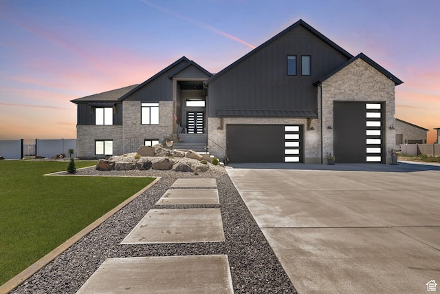 2673 S 4950 W, Taylor, UT 84401 - contemporary house with concrete driveway, a lawn, stone siding, and board and batten siding