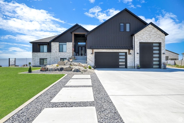 2673 S 4950 W, Taylor, UT 84401 - modern home featuring an attached garage, concrete driveway, board and batten siding, a standing seam roof, and a front yard