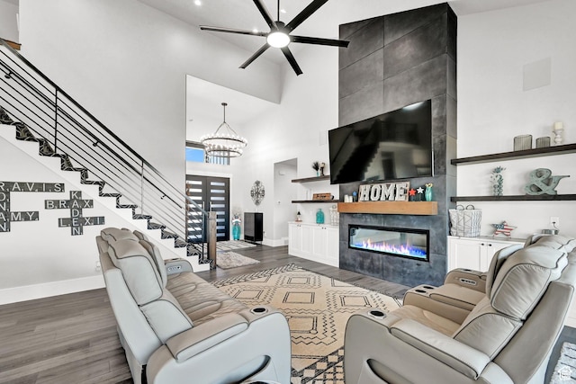 2673 S 4950 W, Taylor, UT 84401 - living room with baseboards, a tile fireplace, dark wood-style flooring, stairs, and a high ceiling