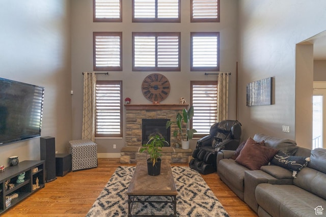 926 N 1875 W, Farmington, UT 84025 - living area with a fireplace, a high ceiling, baseboards, and wood finished floors