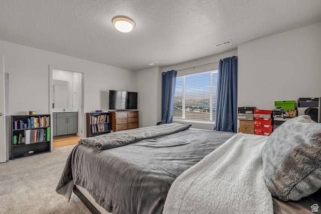 1982 N Red Yearling Dr, Saratoga Springs, UT 84045 - carpeted bedroom featuring ensuite bathroom, visible vents, a textured ceiling, and a sink